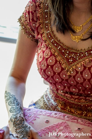Indian bride gets bridal mehndi done on arms and hands