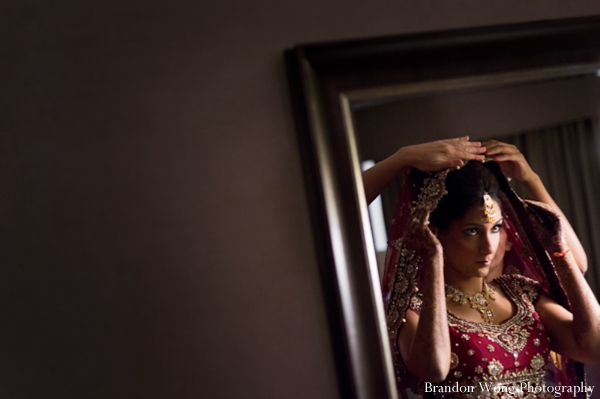 Indian bride in a pink wedding lengha.