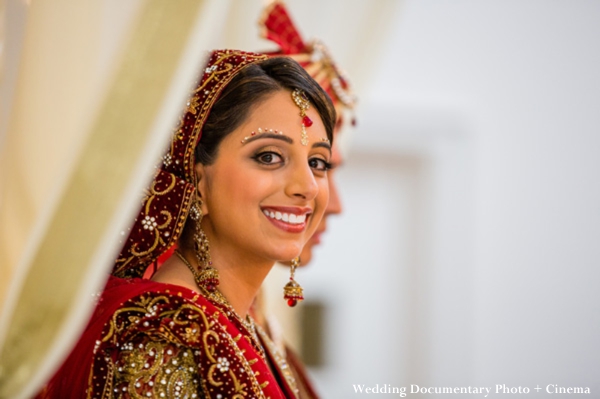 Indian bride in traditional red wedding lengha.