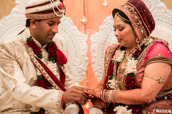 indian bride and groom exchange rings at indian wedding ceremony