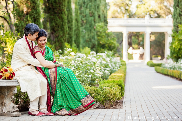 Fusion indian wedding couple wears traditional wedding outfits.