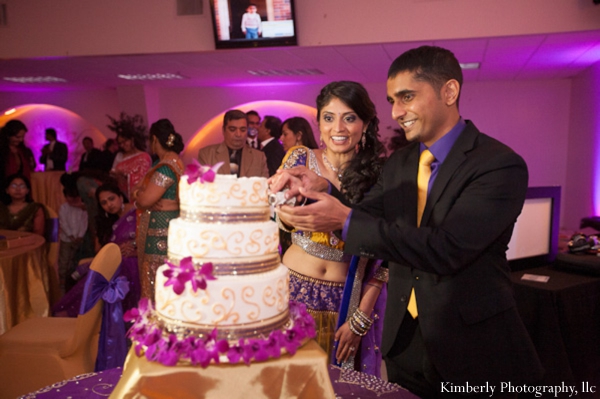 indian bride and groom cut into indian wedding cake