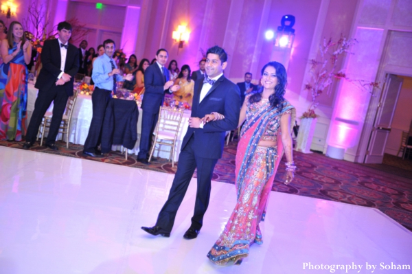 indian bride and groom enter indian wedding reception.