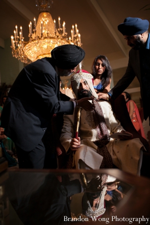 Indian groom wears veil at his indian wedding
