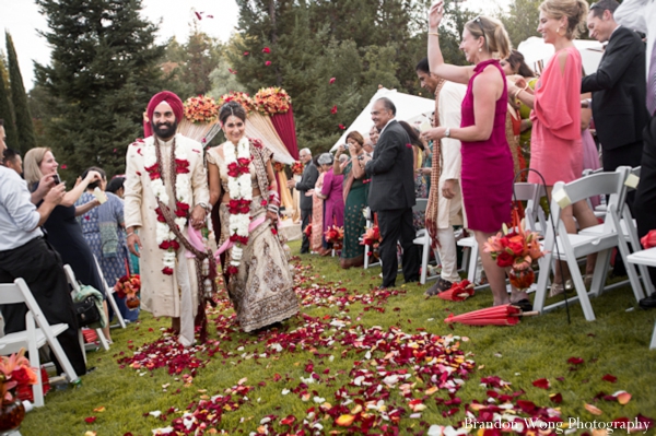 Indian bride in bridal lengha with long jaimala flower garland