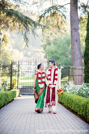 Fusion Indian wedding couple walk with jaimalas.