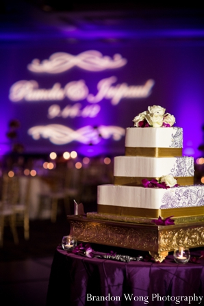 Indian wedding cake in white and gold on pedastal