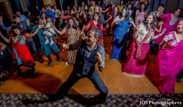 Indian wedding guests dance at south indian wedding