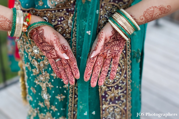 Indian bride with bridal mehndi on hands.