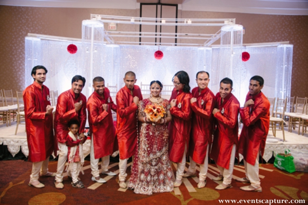 Indian bride with her Indian wedding groomsmen in red kurtas.
