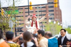 A groom leads the baraat procession to his wedding ceremony.