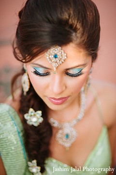 A soft green and teal makeup look for a sangeet.