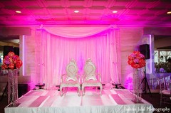A sweetheart stage at vibrant reception for an Indian newlywed couple.