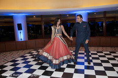 An Indian bride and groom class it up for their wedding reception!