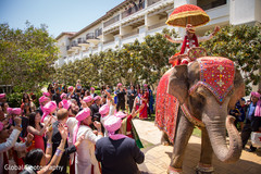 The groom comes in on an elephant in the baraat!