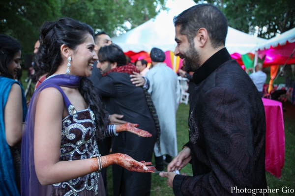 An Indian bride shows off her bridal mehndi to her groom.