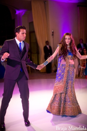 https://www.maharaniweddings.com/wp-content/uploads/2012/11/indian-wedding-reception-dance-purple-gold-lengha-black-suit-dance.jpg